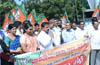 BJP stages protest ; demands resignation of ministers K J George, Vinay Kulkarni